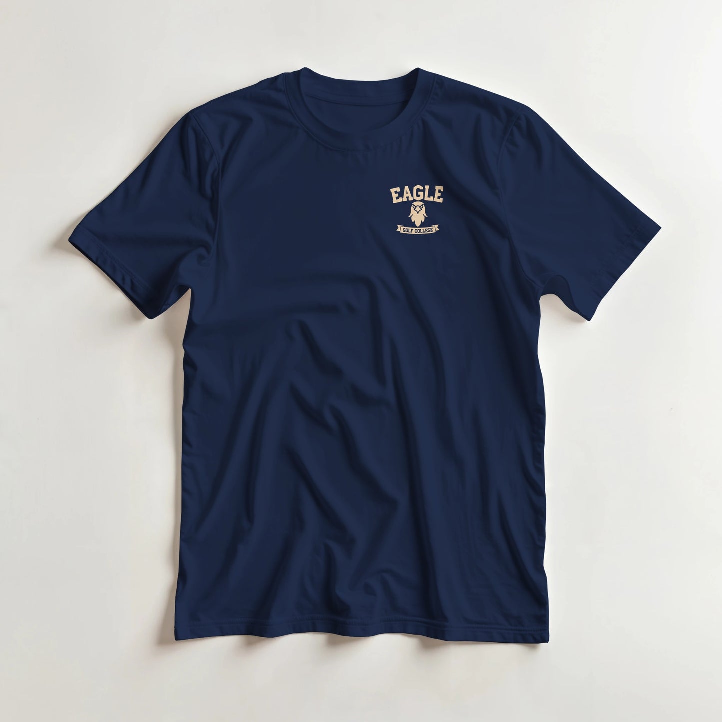 Eagle College (Pocket) T-Shirt in Navy lying on a plain floor. T-shirt is a unisex cut and 100 per cent cotton.