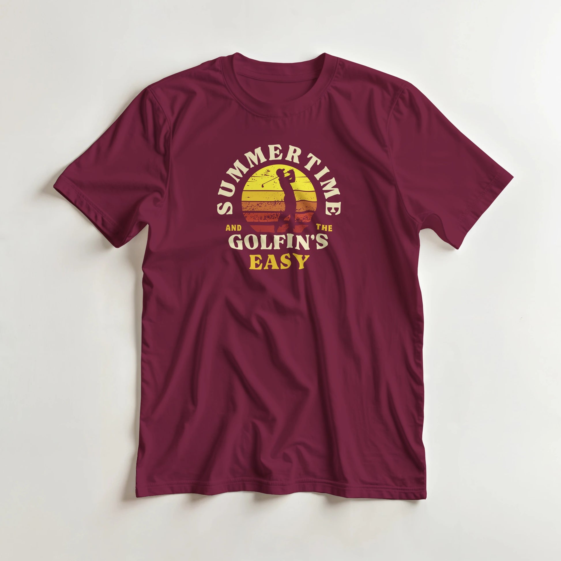 Summertime T-Shirt in Maroon lying on a plain floor. T-shirt is a unisex cut and 100 per cent cotton.