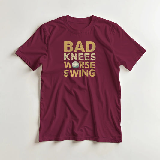 Bad Knees II T-Shirt in Maroon S lying on a plain floor. T-shirt is a unisex cut and 100 per cent cotton.
