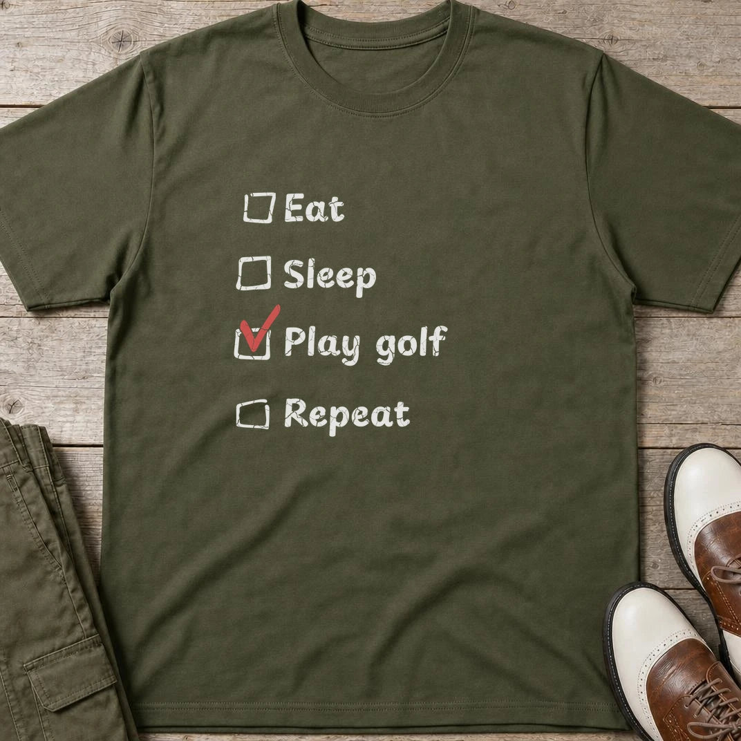 Golf Repeat T-Shirt in Military Green lying on a plain floor. T-shirt is a unisex cut and 100 per cent cotton.