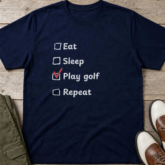 Golf Repeat T-Shirt in Navy lying on a plain floor. T-shirt is a unisex cut and 100 per cent cotton.