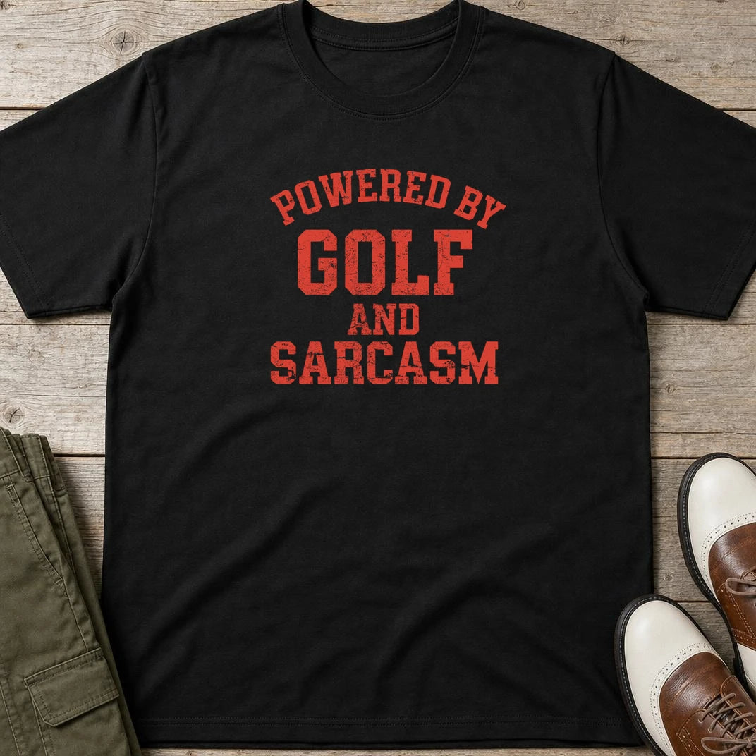 Powered By T-Shirt in Black lying on a plain floor. T-shirt is a unisex cut and 100 per cent cotton.