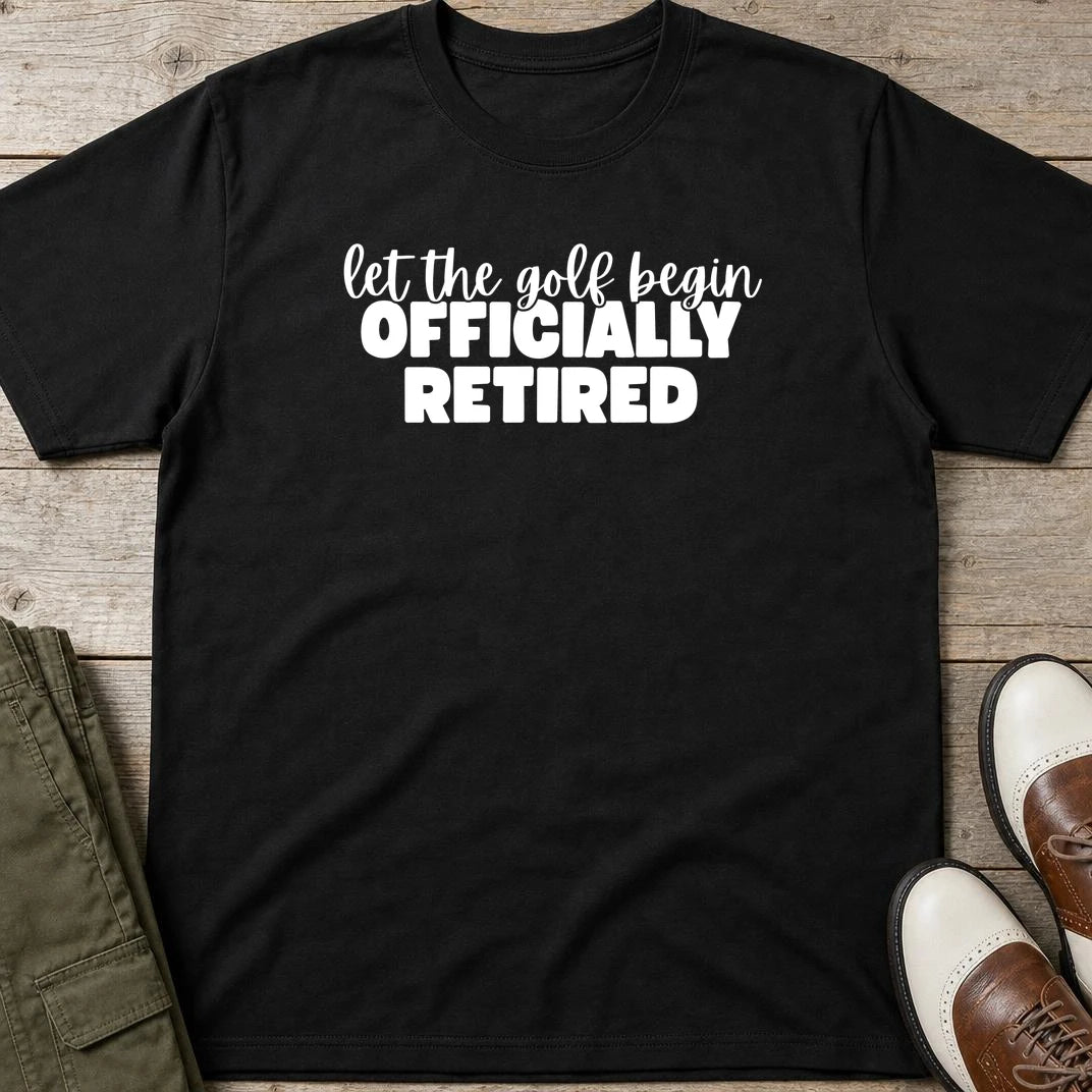 Golf Begin T-Shirt in Black lying on a plain floor. T-shirt is a unisex cut and 100 per cent cotton.