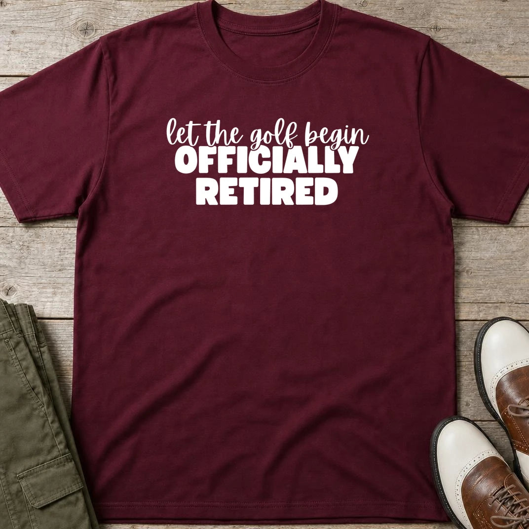 Golf Begin T-Shirt in Maroon lying on a plain floor. T-shirt is a unisex cut and 100 per cent cotton.