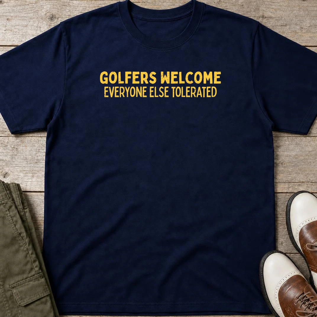 Golfers Welcome T-Shirt in Navy lying on a plain floor. T-shirt is a unisex cut and 100 per cent cotton.