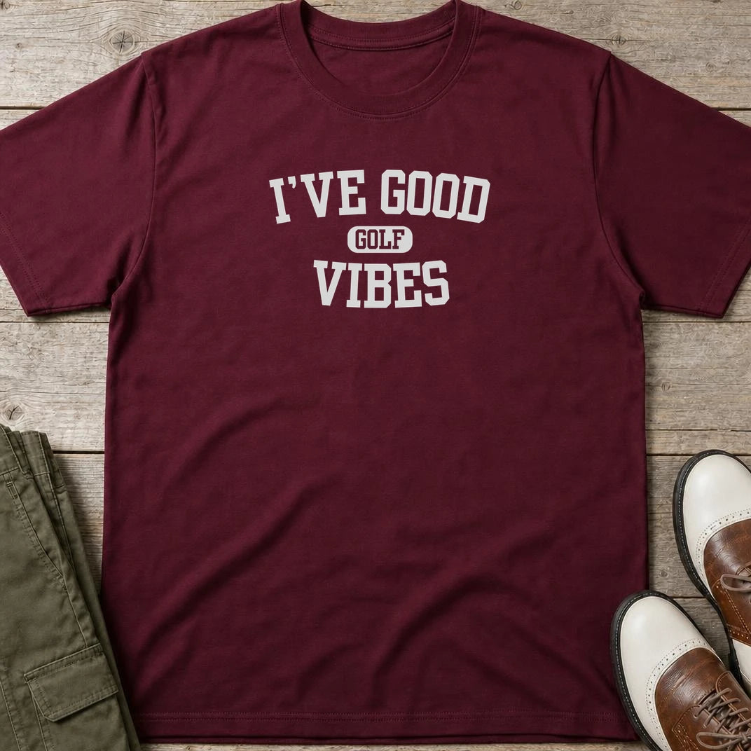Golf Vibes T-Shirt in Maroon lying on a plain floor. T-shirt is a unisex cut and 100 per cent cotton.