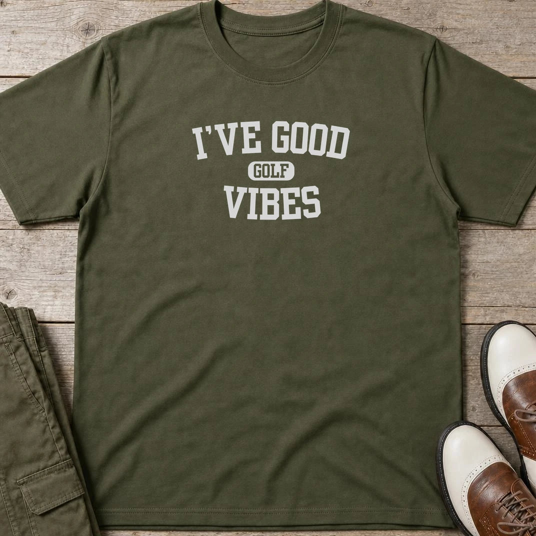 Golf Vibes T-Shirt in Military Green lying on a plain floor. T-shirt is a unisex cut and 100 per cent cotton.