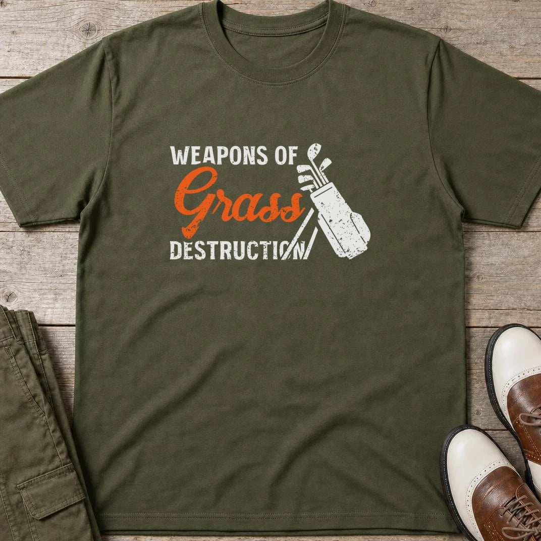 Weapons T-Shirt in Military Green lying on a plain floor. T-shirt is a unisex cut and 100 per cent cotton.