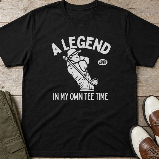 Own Tee Time T-Shirt in Black lying on a plain floor. T-shirt is a unisex cut and 100 per cent cotton.