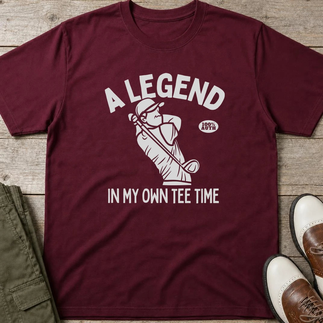 Own Tee Time T-Shirt in Maroon lying on a plain floor. T-shirt is a unisex cut and 100 per cent cotton.
