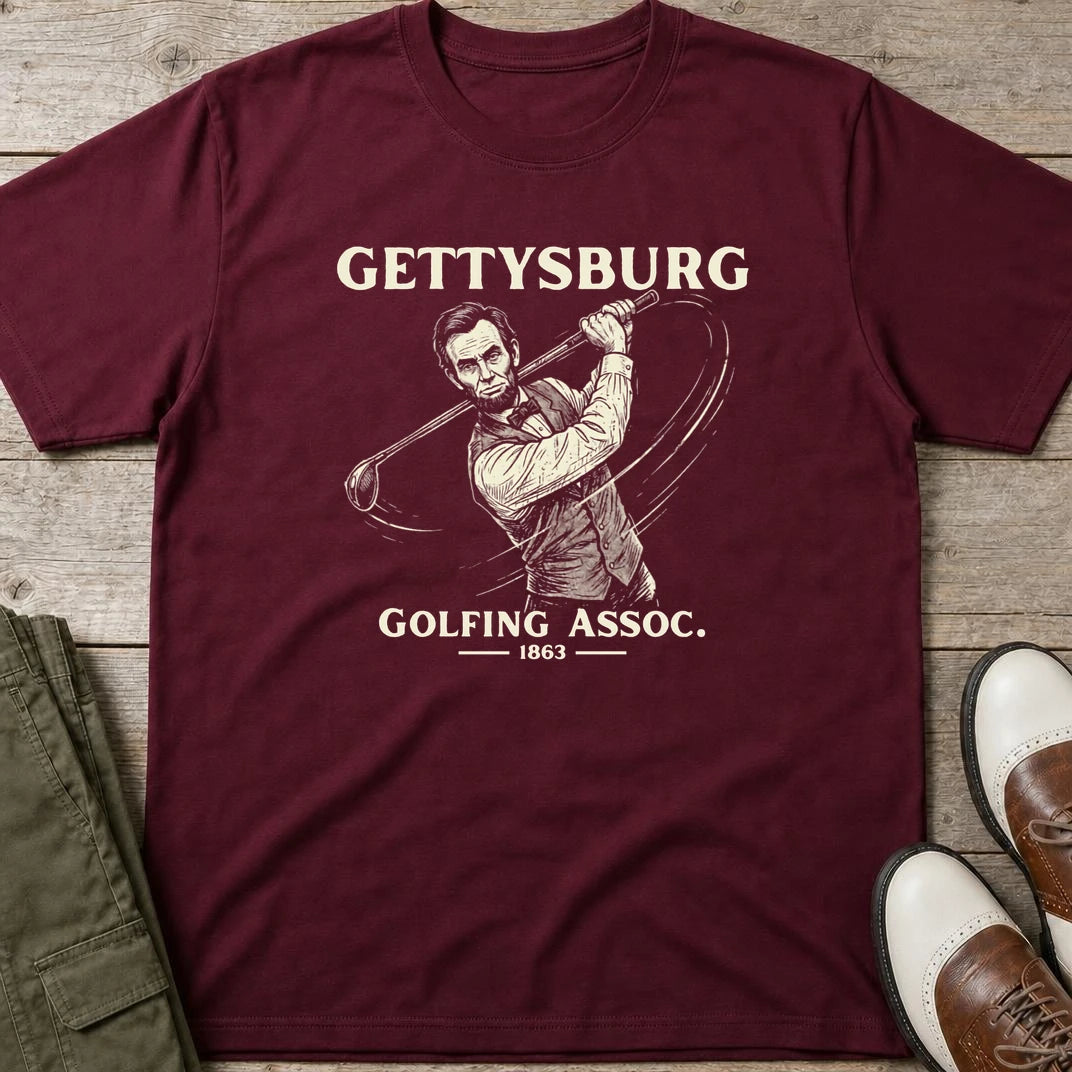 Gettysburg T-Shirt in Maroon lying on a plain floor. T-shirt is a unisex cut and 100 per cent cotton.