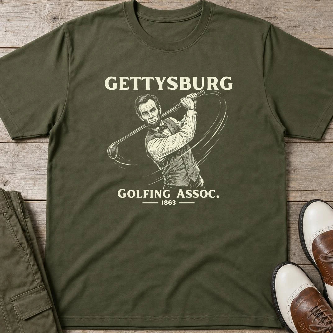 Gettysburg T-Shirt in Military Green lying on a plain floor. T-shirt is a unisex cut and 100 per cent cotton.