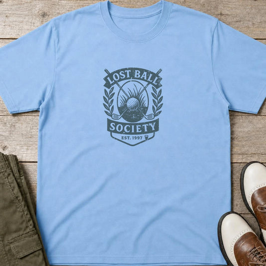 Lost Ball Society T-Shirt in Light Blue lying on a plain floor. T-shirt is a unisex cut and 100 per cent cotton.