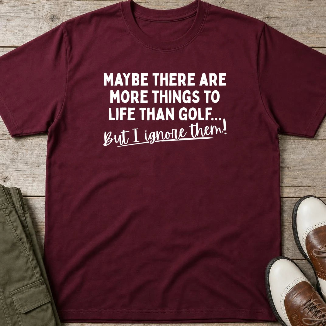 More Things T-Shirt in Maroon lying on a plain floor. T-shirt is a unisex cut and 100 per cent cotton.