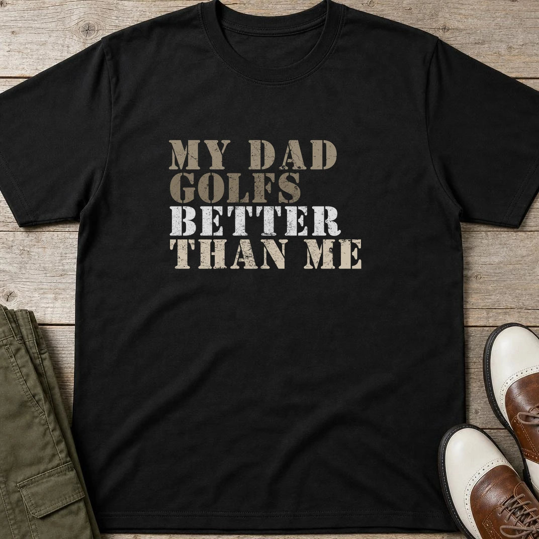 My Dad Golfs T-Shirt in Black lying on a plain floor. T-shirt is a unisex cut and 100 per cent cotton.