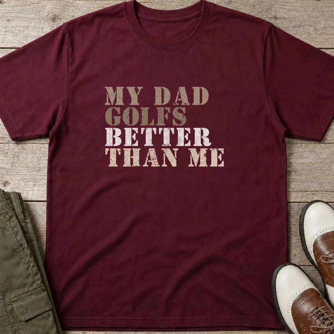My Dad Golfs T-Shirt in Maroon lying on a plain floor. T-shirt is a unisex cut and 100 per cent cotton.