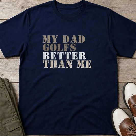 My Dad Golfs T-Shirt in Navy lying on a plain floor. T-shirt is a unisex cut and 100 per cent cotton.