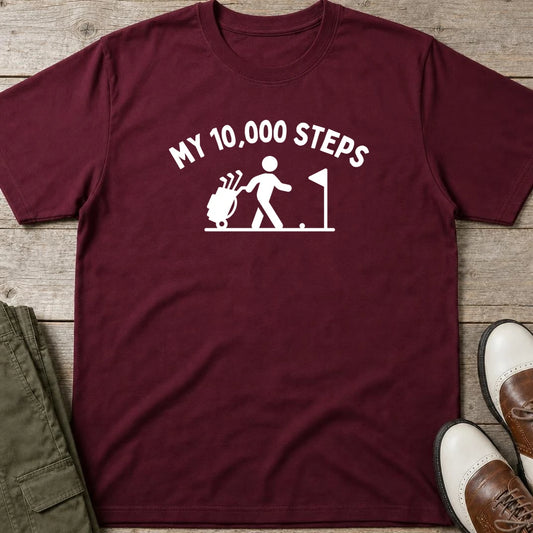 My 10,000 Steps T-Shirt in Maroon lying on a plain floor. T-shirt is a unisex cut and 100 per cent cotton.