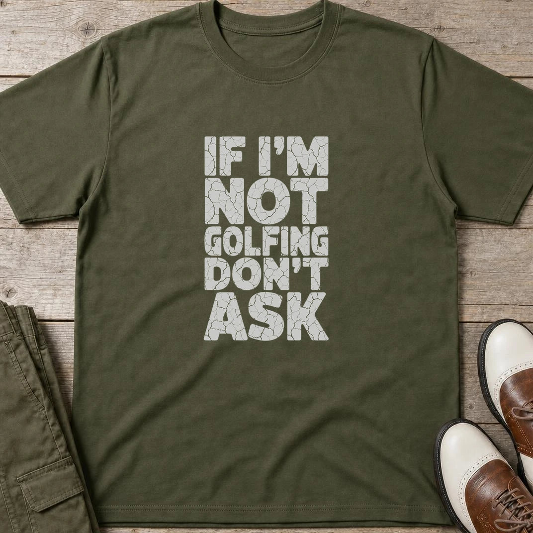 Not Golfing T-Shirt in Military Green lying on a plain floor. T-shirt is a unisex cut and 100 per cent cotton.
