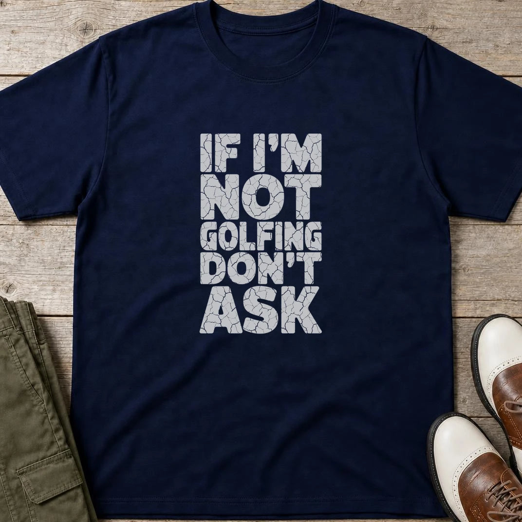 Not Golfing T-Shirt in Navy lying on a plain floor. T-shirt is a unisex cut and 100 per cent cotton.