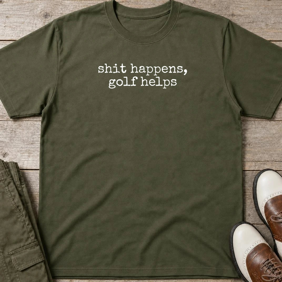 Shit Happens T-Shirt in Military Green lying on a plain floor. T-shirt is a unisex cut and 100 per cent cotton.