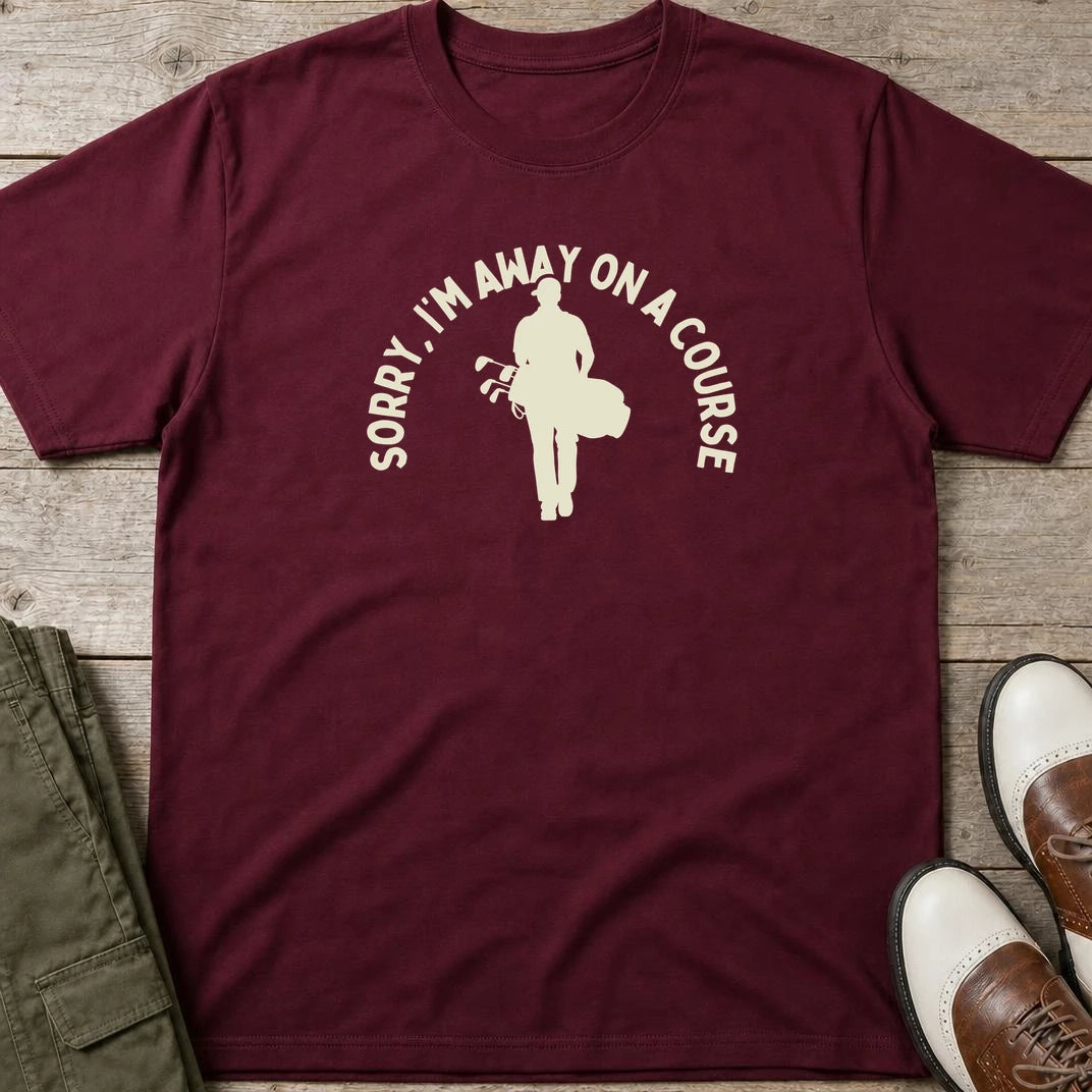 On A Course T-Shirt in Maroon lying on a plain floor. T-shirt is a unisex cut and 100 per cent cotton.