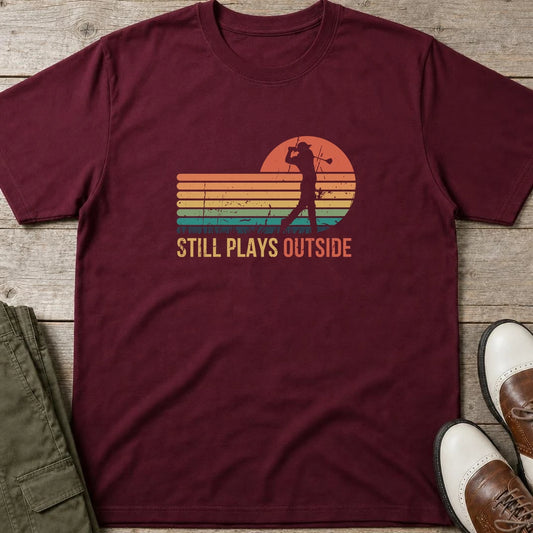 Plays Outside T-Shirt in Maroon lying on a plain floor. T-shirt is a unisex cut and 100 per cent cotton.