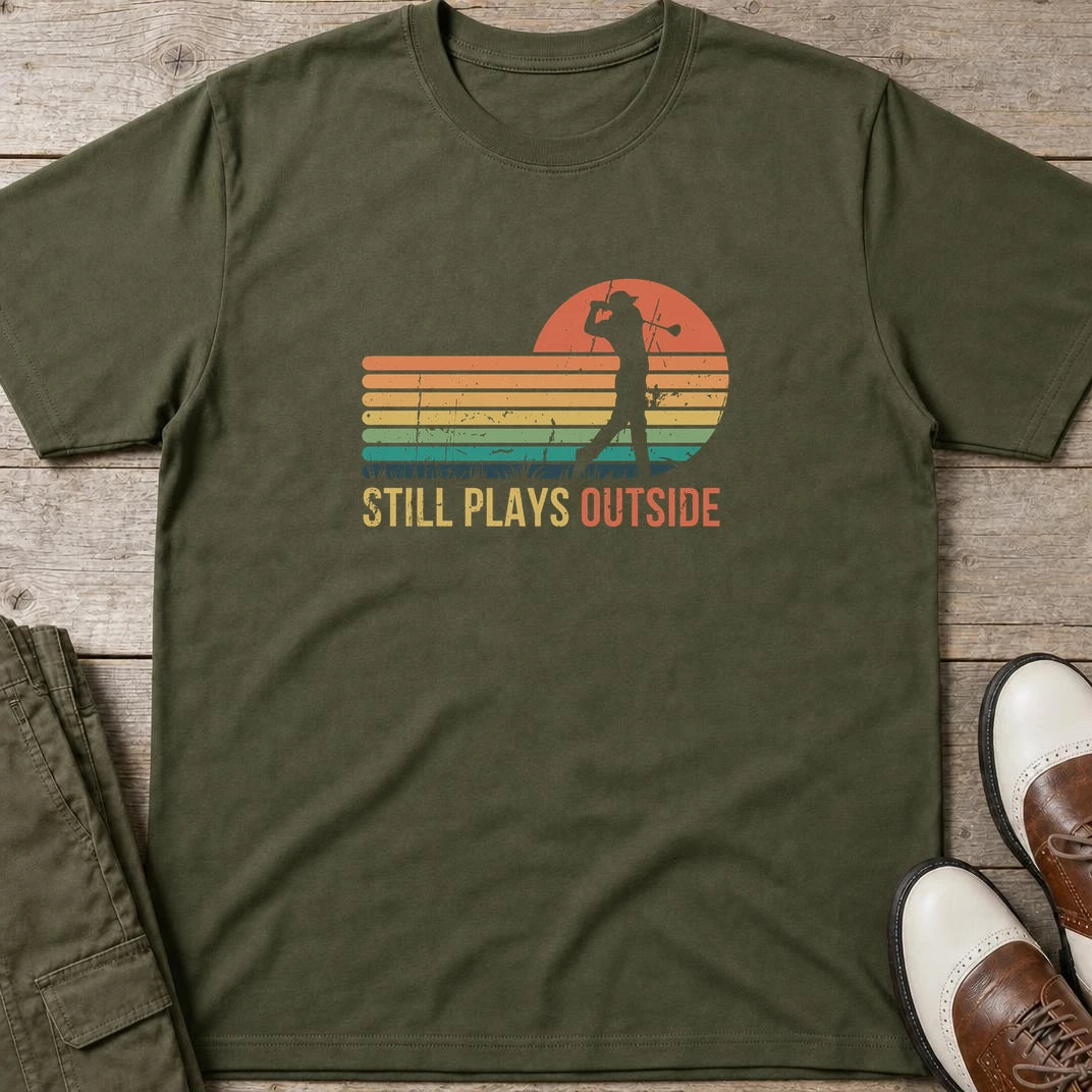 Plays Outside T-Shirt in Military Green lying on a plain floor. T-shirt is a unisex cut and 100 per cent cotton.