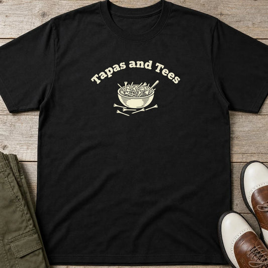 Tapas T-Shirt in Black lying on a plain floor. T-shirt is a unisex cut and 100 per cent cotton.