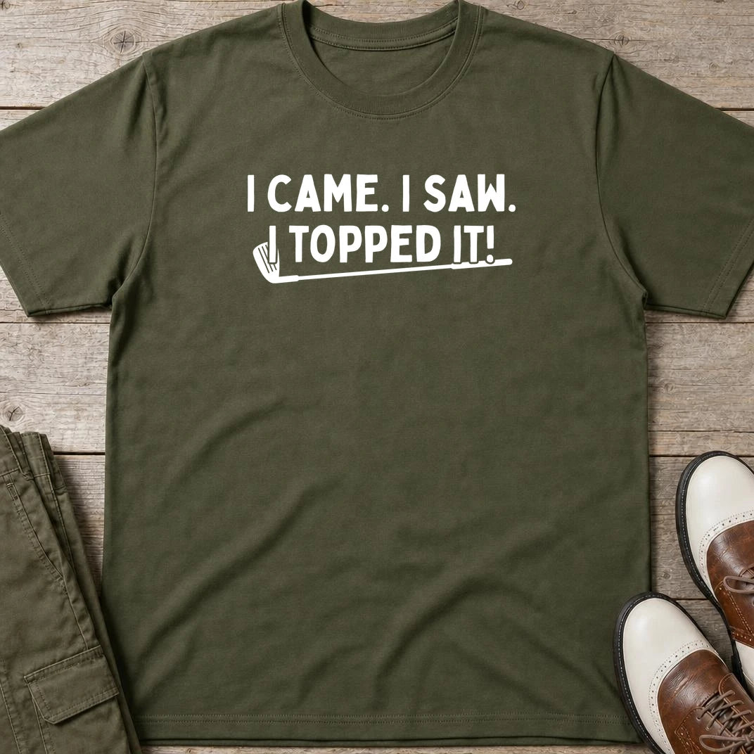 Topped It T-Shirt in Military Green lying on a plain floor. T-shirt is a unisex cut and 100 per cent cotton.
