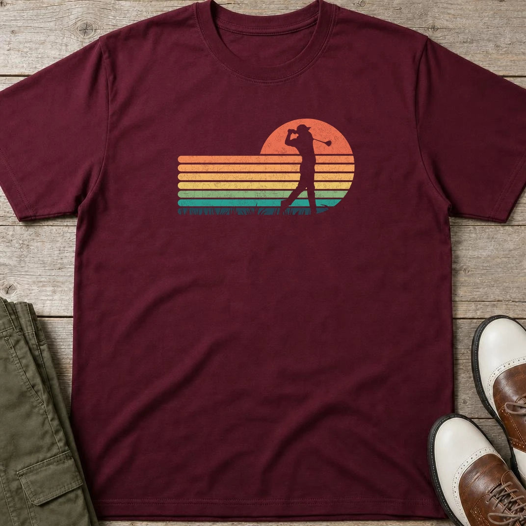 Vintage Golfer T-Shirt in Maroon lying on a plain floor. T-shirt is a unisex cut and 100 per cent cotton.