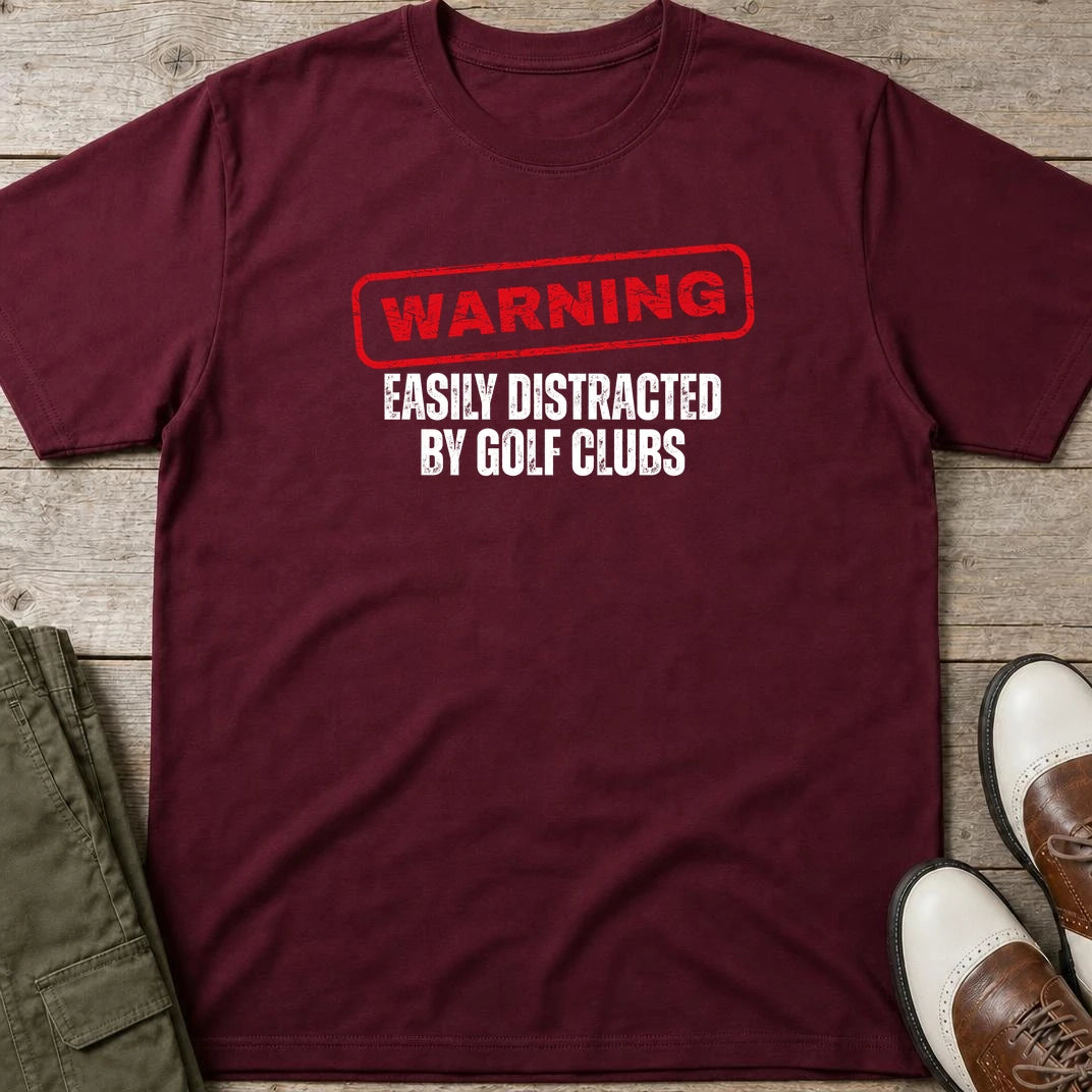 Warning T-Shirt in Maroon lying on a plain floor. T-shirt is a unisex cut and 100 per cent cotton.