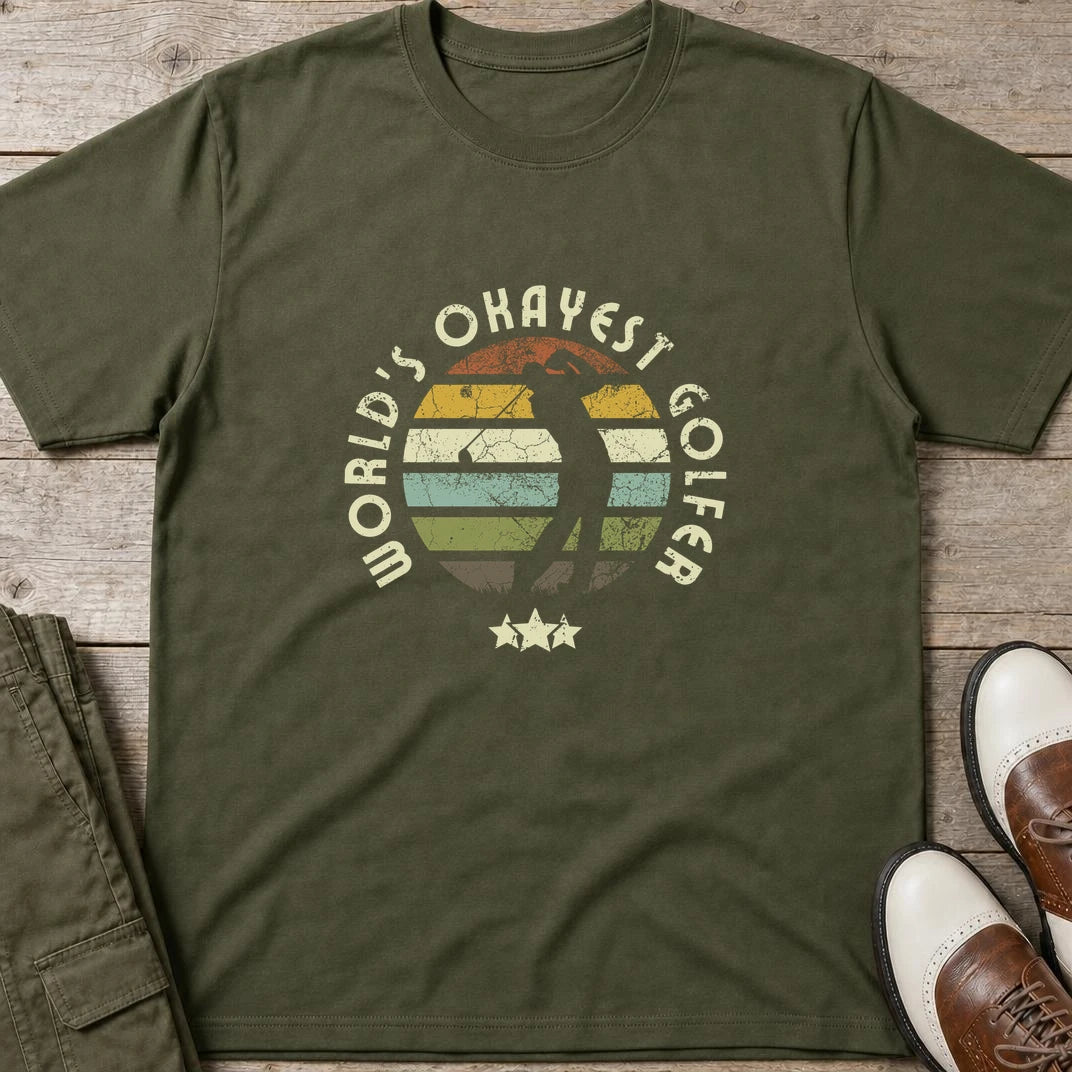 Okayest Golfer T-Shirt in Military Green lying on a plain floor. T-shirt is a unisex cut and 100 per cent cotton.