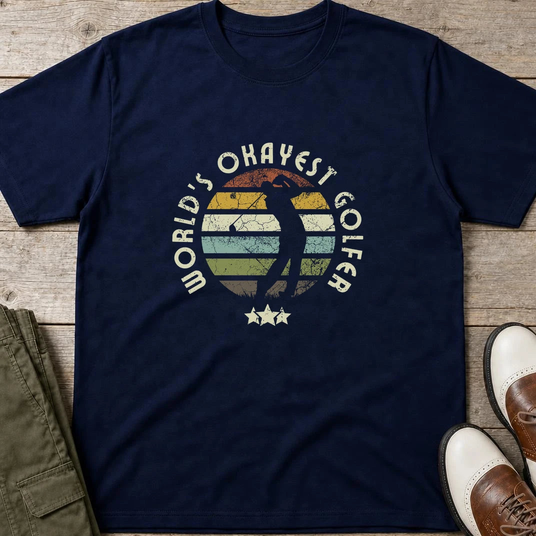 Okayest Golfer T-Shirt in Navy lying on a plain floor. T-shirt is a unisex cut and 100 per cent cotton.